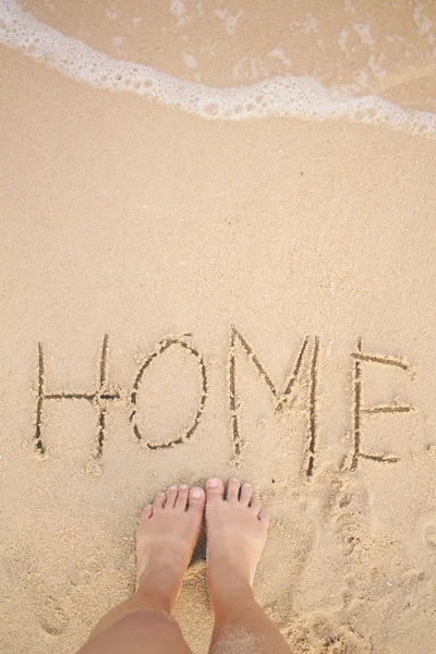 Selfie of word home written in sand on beach — Stock Photo, Image