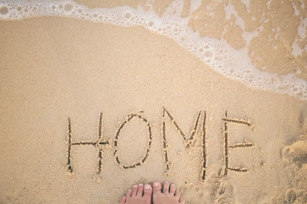 Selfie of word home written in sand on beach — Stock Photo, Image