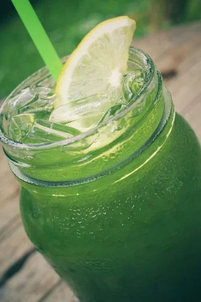 Ice green tea with lemon on a jar — Stock Photo, Image