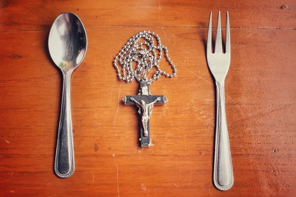 Spoon and fork with necklace cross — Stock Photo, Image