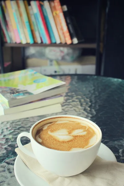 Vintage latte art coffee with book — Stock Photo, Image