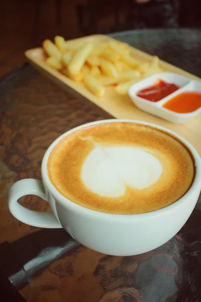 Latte art coffee with french fries — Stock Photo, Image
