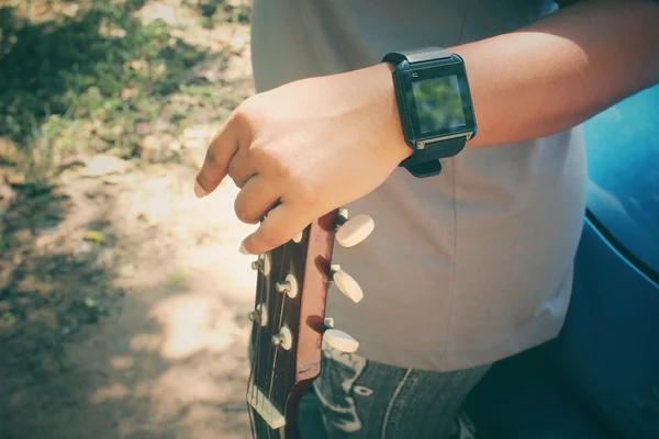 Woman playing the guitar with smartwatch — Stock fotografie