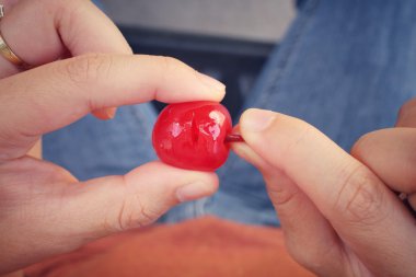 Young woman eating cherries