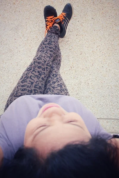 Mujer joven con zapatillas en la pared —  Fotos de Stock