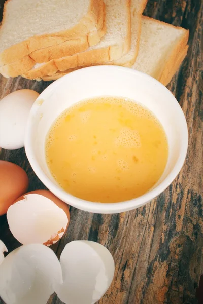 Eggs in a bowl with bread — Stock Photo, Image