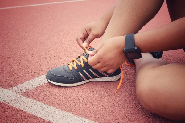 Mujer manos atando cordones de zapatos con smartwatch — Foto de Stock