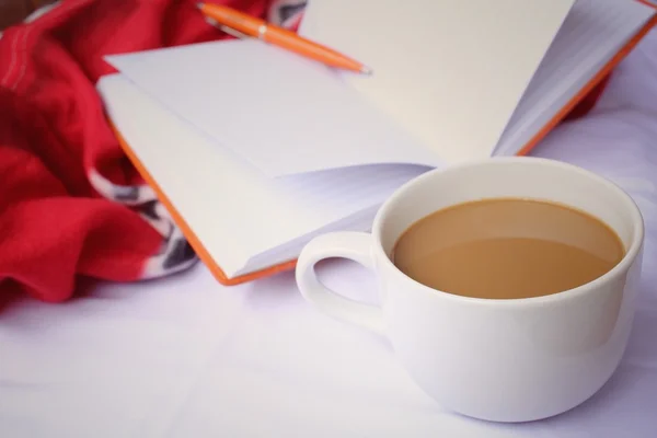 Coffee cup with book on the bed — Stock Photo, Image