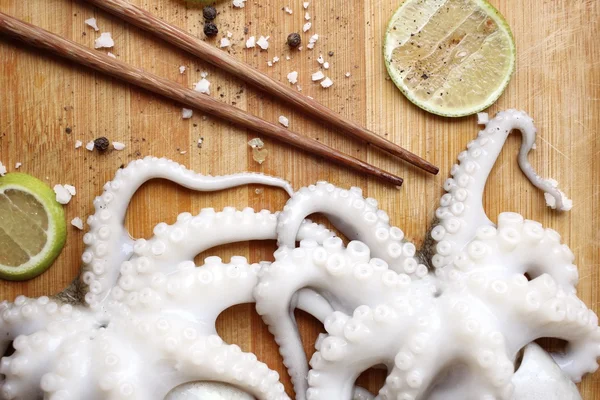 Fresh octopus food lemon salt and pepper — Stock Photo, Image