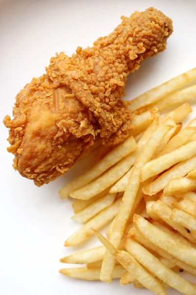 Fried chicken leg with french fries Royalty Free Stock Photos