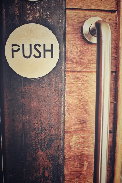 Vintage door with push sign — Stock Photo, Image