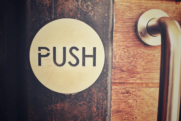 Vintage door with push sign — Stock Photo, Image