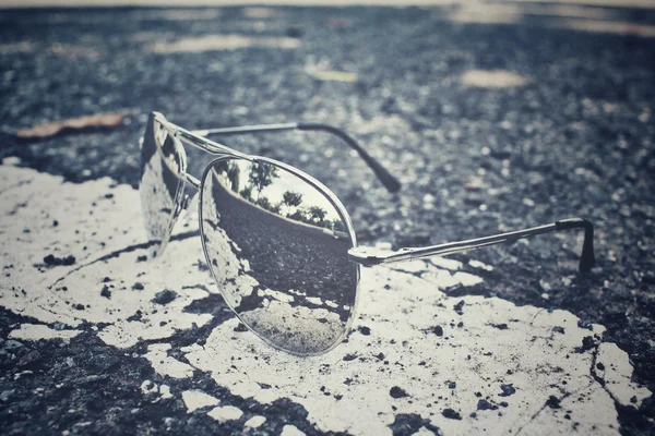 Sun glasses with reflection and road — Stock Photo, Image