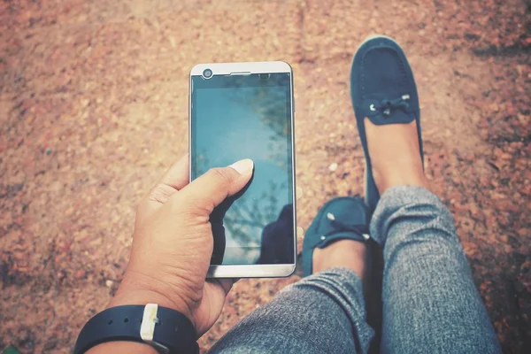 Selfie of smart phone on hand with shoes — Stock Photo, Image