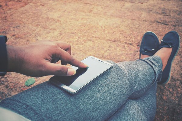Selfie of smart phone on hand with shoes