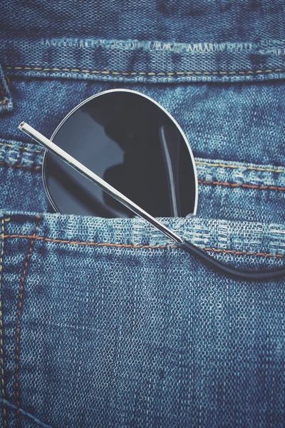 Glasses in jeans pocket — Stock Photo, Image