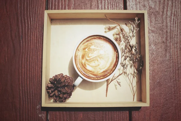 Vintage latte coffee with dried flowers — Stock Photo, Image