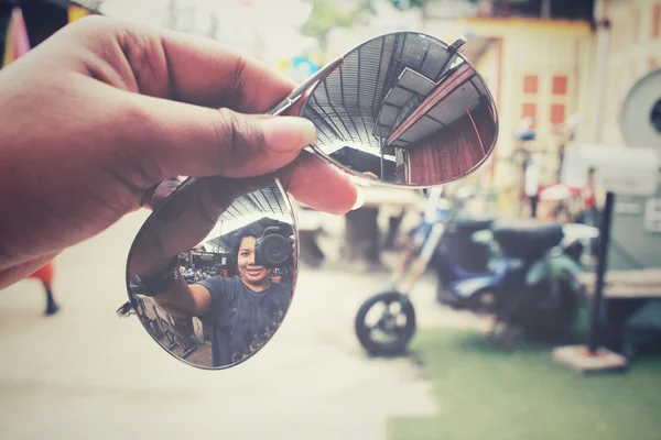 Sun glasses with reflection of woman take a photo — Stock Photo, Image