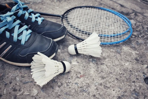 Chaussures de sport avec navettes et raquette de badminton . — Photo