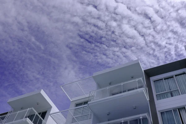 low rise modern architecture in blue cloud sky