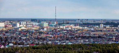 Panoramic view of Yakutsk skyline with TV tower and center of the city in the evening clipart