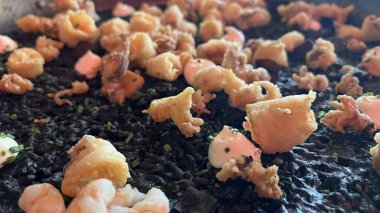 Black rice with sheafood on a plate.