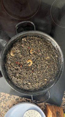 Black rice with sheafood on a plate.