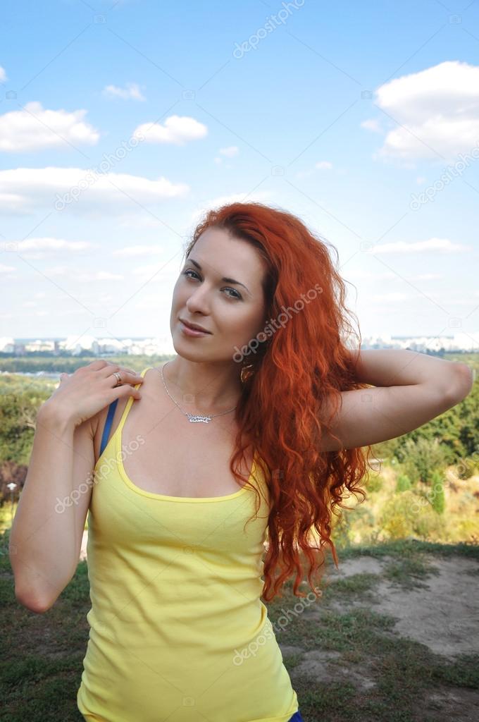 Red-haired girl in the yellow-blue clothes