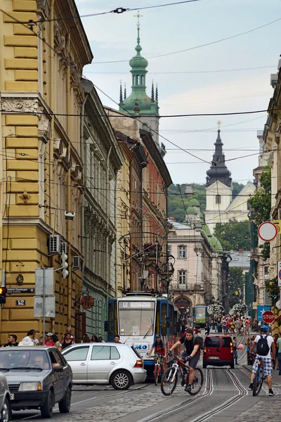 Lviv, Ucrania - 5 de agosto de 2015: Paisaje urbano de Lviv. Vista de la calle Lviv con la arquitectura antigua, coches, tranvías y personas — Foto de Stock