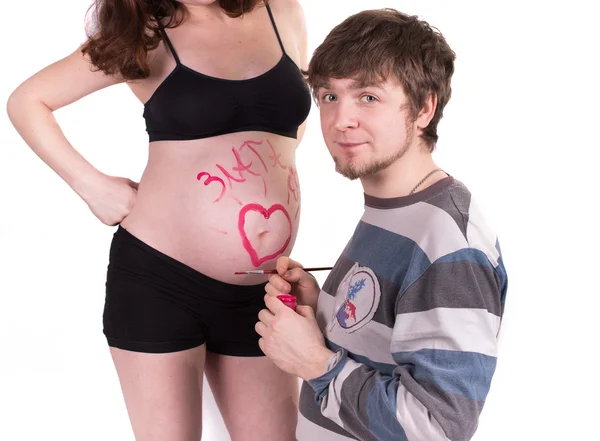 合作伙伴画一个问号在孕妇的肚子 — 图库照片