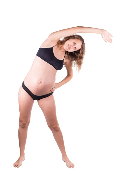 Smiley zwangere vrouw stretching oefening doen. geïsoleerd op witte achtergrond — Stockfoto