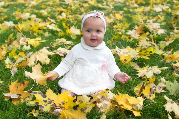 Hermosa niña de pie en un parque en otoño — Foto de Stock