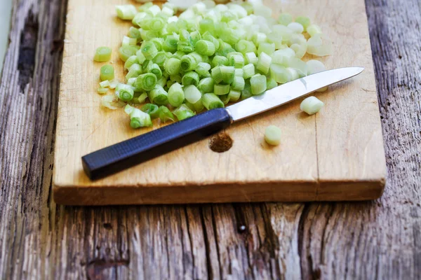 Cutting Onion on a wooden board — Stock Photo, Image