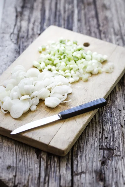 Cutting Onion on a wooden board — Stock Photo, Image