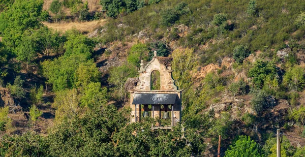 Vintage belfry long shot against the hillside — Stock Photo, Image