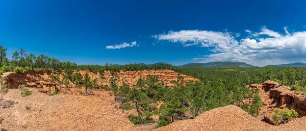 Panoramic view of ground collapse and pine trees — Stock Photo, Image