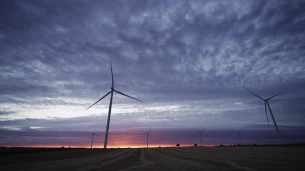 Spectaculaire zonsondergang met draaiende windmolens, wormen oogzicht — Stockvideo