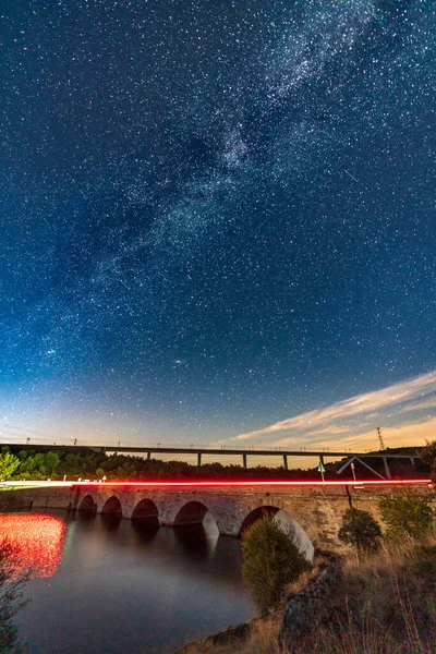 Two bridges and milky way with car light trails — Stock Photo, Image