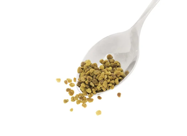 Side view of silver spoon with bee pollen, white background — Stock Photo, Image