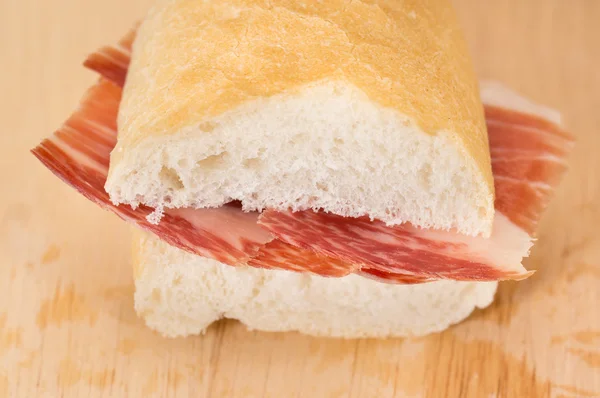 Front view of Serrano ham sandwich over wood — Stock Photo, Image
