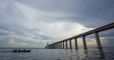 The center of Manaus Iranduba Bridge and boat clipart