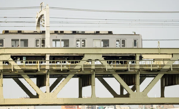 Side view of train over iron bridge — Stock Photo, Image