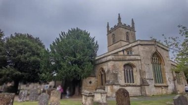 A timelapse shows tourists at Stow-on-the-Wolds famous yew tree church door, highlighting its unique blend of history, architecture, and spirituality.