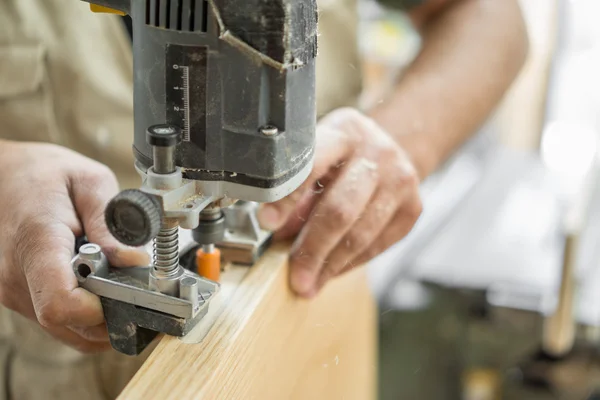 Blurred motion of carpenter working, preparing door for hinges — Stock Photo, Image