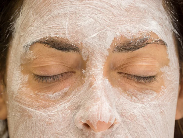 Woman closed eyes and forehead with mudpack and nose, front view — Stock Photo, Image