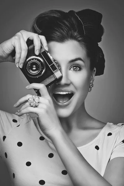 Girl with retro camera Stock Image
