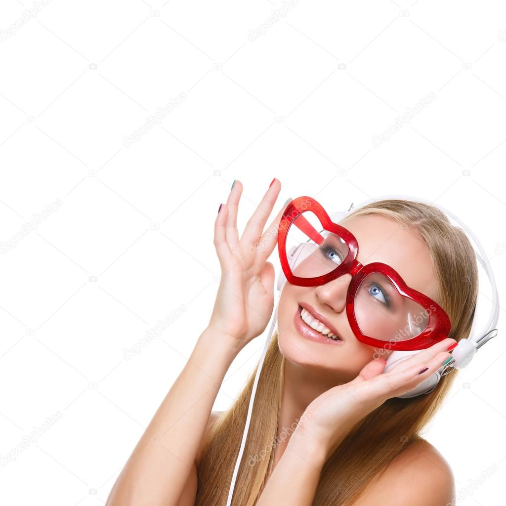 Girl in headphones and heart shaped glasses