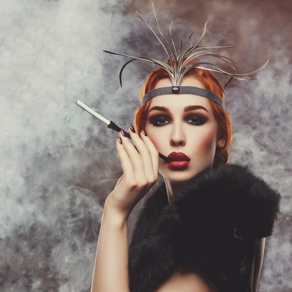 Beautiful girl with smoky eyes and red lips holding cigarette — Stock Photo, Image