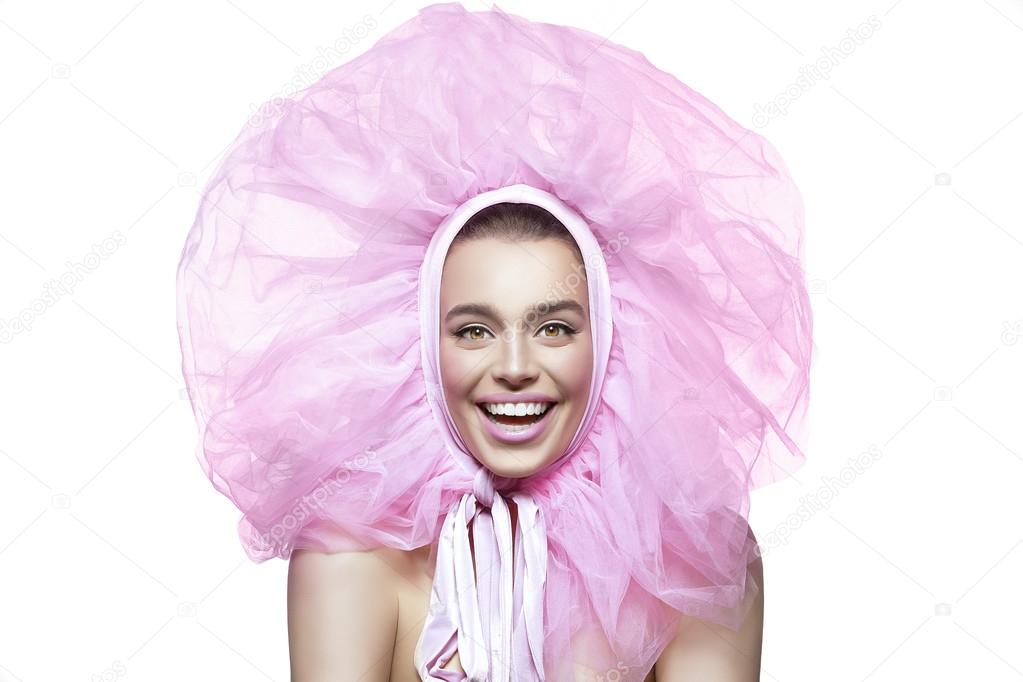 Beautiful happy girl with pink veil around head