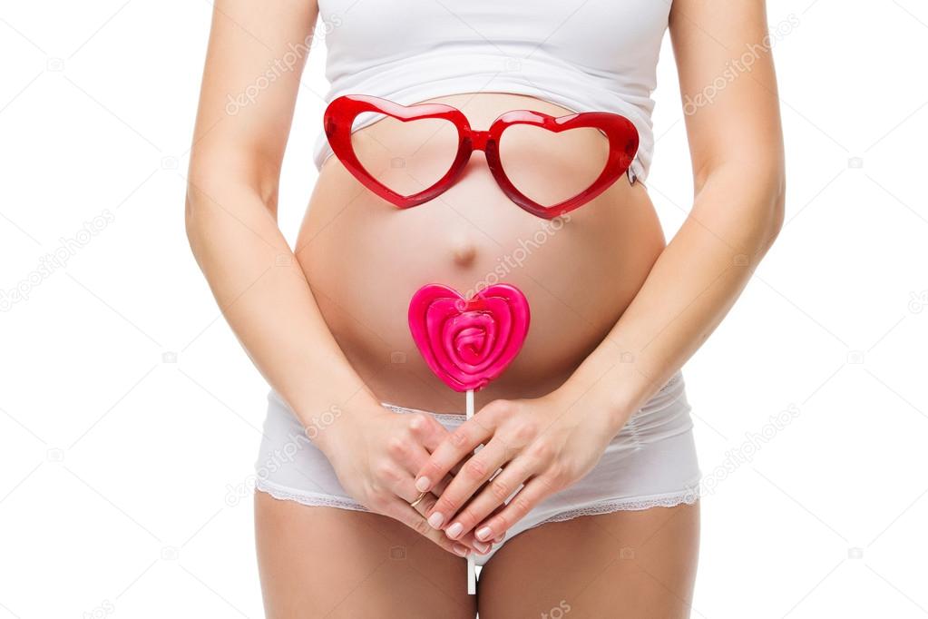 heart shaped glasses on pregnant belly
